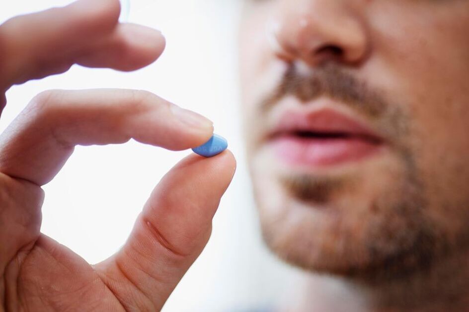 a man takes a pill to boost power